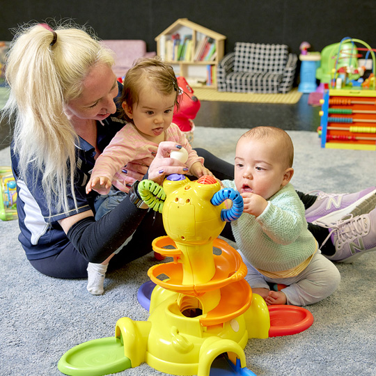  AKAC creche staff supervising 2 babies playing